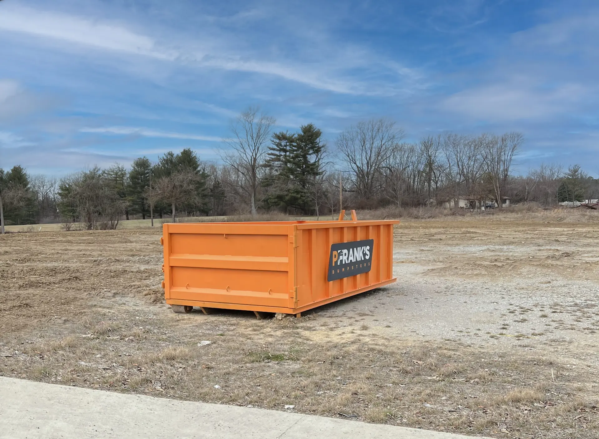 pfrank dumpster in a field